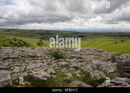 The limestone pavement on the top of Malham Cove, and the view down Malhamdale , North Yorkshire, England, UK Stock Photo