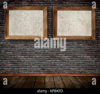 Old-fashioned wooden frames with canvas on bricks wall. Stock Photo