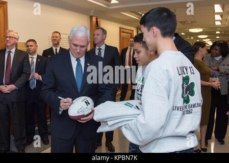 U.S. Vice President Mike Pence signs a football during the U.S. Naval Academy pep rally at the Pentagon December 7, 2017 in Washington, DC. Stock Photo