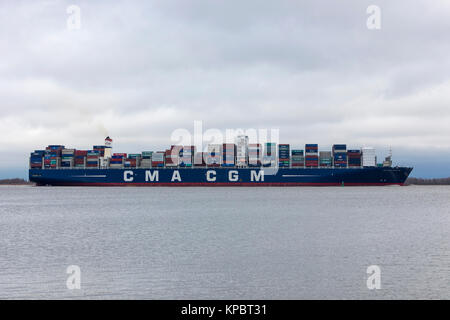 Hollern, Germany - December 14, 2017: Container ship CMA CGM ZHENG HE on Elbe river on her way to Hamburg. Stock Photo