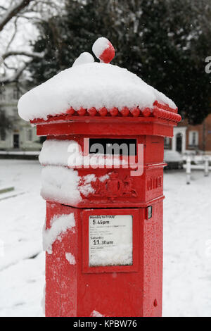Red post box in the snow Stock Photo