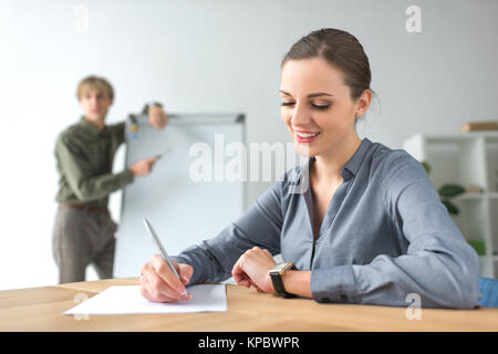 businesswoman writing down something Stock Photo