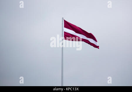 Latvian Flag in Autumn Blue Sky Stock Photo