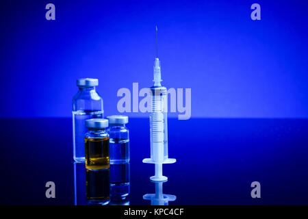 Syringe and medical vials Stock Photo