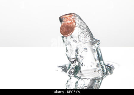 Coin splash in water caught with high speed photography, on a white background Stock Photo