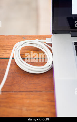 Charge battery laptop on work station Stock Photo