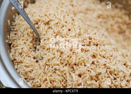 Large portion of glutinouos rice in pot, washed and seasoned for cooking. Stock Photo