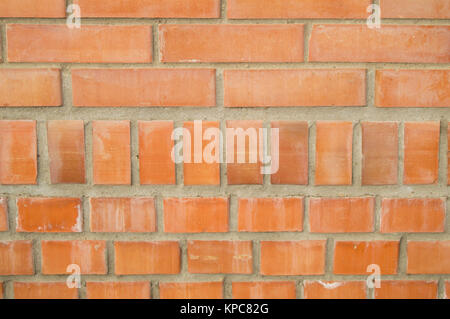 Background of orange brick wall, bricks with cement. Stock Photo