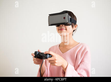 Young Woman play with the virtual reality device Stock Photo