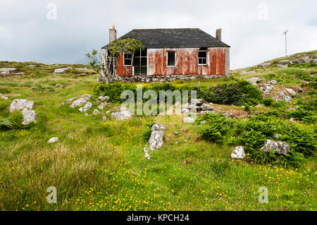 Semi-derelict corrugated iron building on the island of Scalpay in the Outer Hebrides. Stock Photo