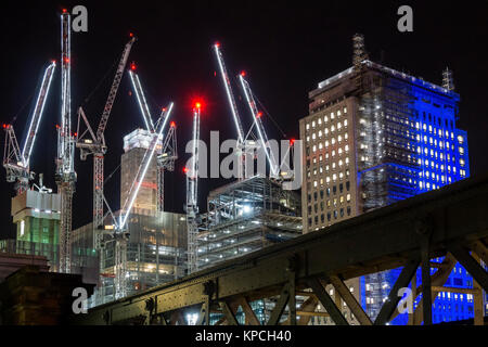Lights on tower cranes at the construction site of the Southbank Place development in London at night. Stock Photo
