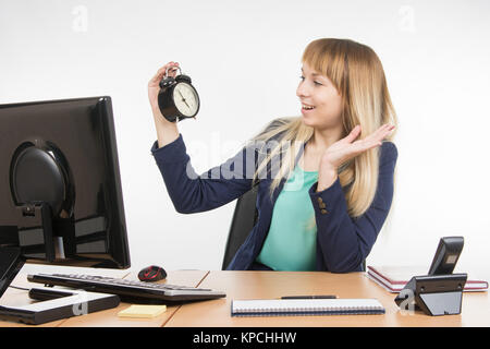 Office saw a specialist on the clock that the working day is finished Stock Photo