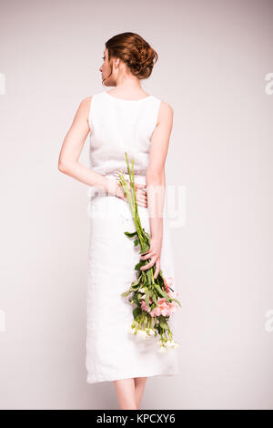 girl in white dress with flowers Stock Photo
