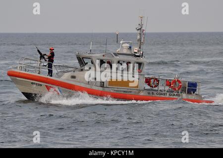 US COAST GUARD ARMED RESPONSE BOAT ESCORT FOR CRUISE SHIPS LEAVING PORT EVERGLADES Stock Photo