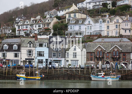 Fishing boats moored on the dockside in Winter in Looe harbour, Cornwall. Stock Photo