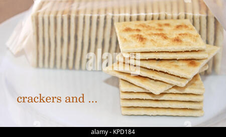 Crackers and ... stack of crispy saltine crackers ready to be enjoyed plain or with a topping Stock Photo