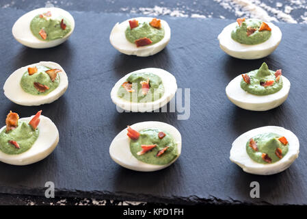 Spinach and bacon deviled eggs Stock Photo