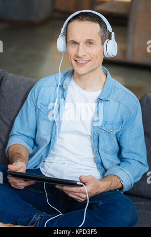 Cheerful freelancer posing straight at camera Stock Photo
