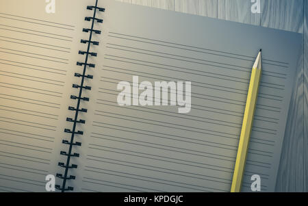 pencil on checked notebook on wood background Stock Photo