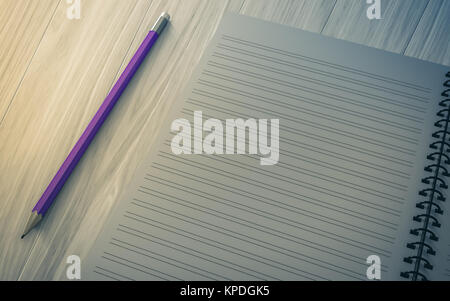 pencil on checked notebook on wood background Stock Photo