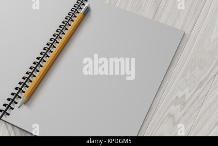 pencil on checked notebook on wood background Stock Photo