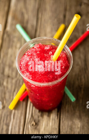 frozen red slushie in plastic cup with straw Stock Photo
