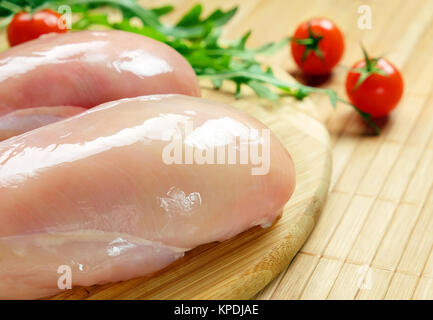 Raw chicken fillet with tomatoes and herbs. Stock Photo
