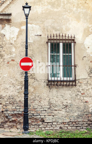 No entry sign hanging on lamp post Stock Photo