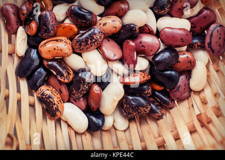 colorful beans in a wicker basket close-up. Stock Photo