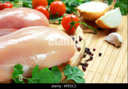 Raw chicken fillet with vegetables and spices. Stock Photo