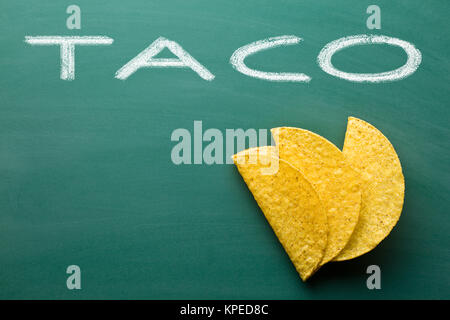 crispy taco shells on chalkboard Stock Photo