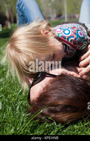 baby and mom hugging lying Stock Photo