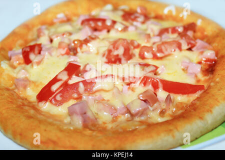 appetizing pizza with sausage and tomatoes Stock Photo