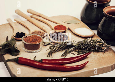 Various spices on kitchen spoons on grunge table Stock Photo