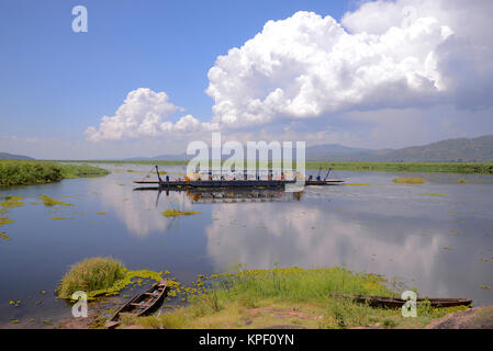 Uganda is called 'The pearl of Africa' because of its beautiful landscapes, friendly people, and abundance of rain. Ferry crossing the Nile river Stock Photo