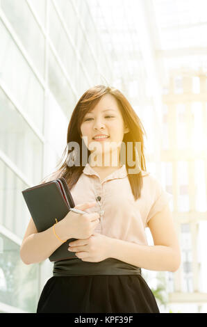 Young Asian female executive walking Stock Photo