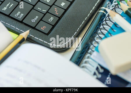 Laptop Tablet Keyboard Opened Textbook Pencil Stack of Notebooks Pen on White Desktop Distance Learning Studying Education Homeschooling Freelance Col Stock Photo