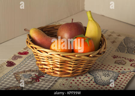 basket of fresh seasonal fruit, mandarin, apple, pear, banana Stock Photo