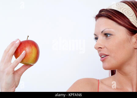 Junge Frau mit Apfel in der Hand - woman with apple Stock Photo