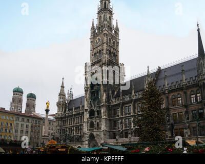 Christmas market stalls in front of Rathaus New Town Hall  and spires of Frauenkirke Marienplatz Munich Bavaria Germany EU Stock Photo