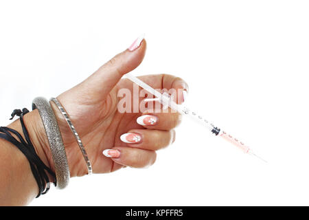 Woman hand holding syringe vaccination on isolated white cutout background. Studio photo with studio lighting easy to use for every concept. Syringe. Stock Photo