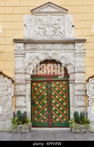 Green old fashioned wooden door on stone facade. Tallinn. Estonia Stock Photo