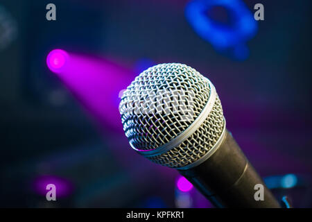 microphone against blur colorful light in music studio Stock Photo