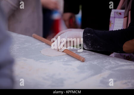 Woman preparing dough for donuts Stock Photo