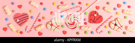Colorful candies on bright pink background, top view Stock Photo