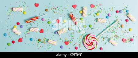 Colorful candies on light blue background, top view Stock Photo