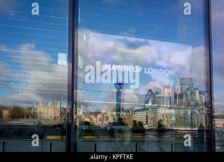 With the City skyline in the distance, the Mayor of London's message appears to Londoners from a screen inside City Hall on the Southbank, on 14th December 2017, in London, England. Stock Photo