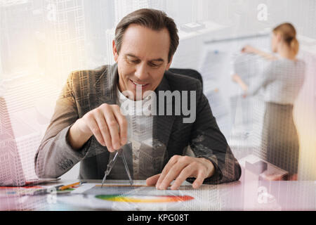 Cheerful senior engineer making a draft in the office Stock Photo