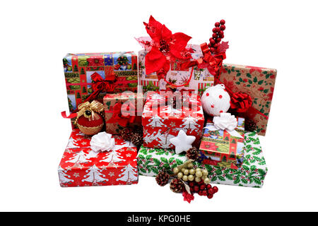 Christmas gifts in boxes and bags, wrapped in themed paper. Decorations with red decorative flowers, Christmas white and golden globes and pine cones Stock Photo