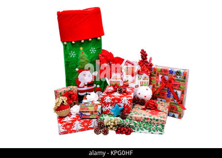 Christmas gifts in boxes and bags, wrapped in themed paper. Decorations with red decorative flowers, Christmas white and golden globes and pine cones Stock Photo